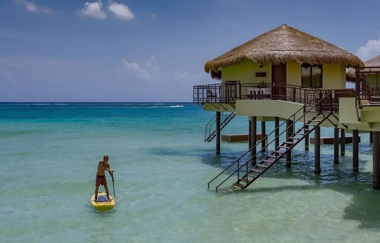 palafitos cancun man in kayak